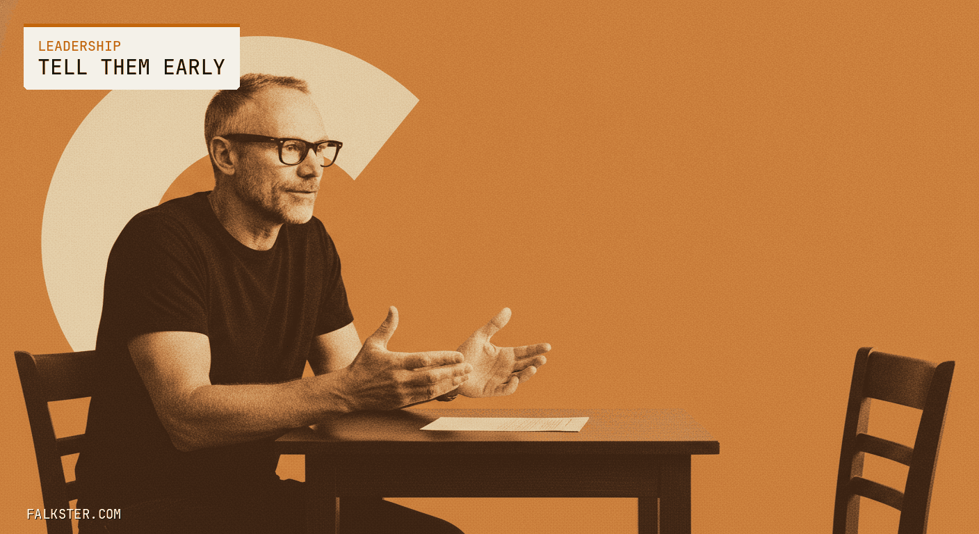 Leadership-amber editorial cover: Falk seated across a small table from an empty chair, leaning in with hands open in an honest conversation, a single document between them, the negative space where a colleague would sit left deliberately open.